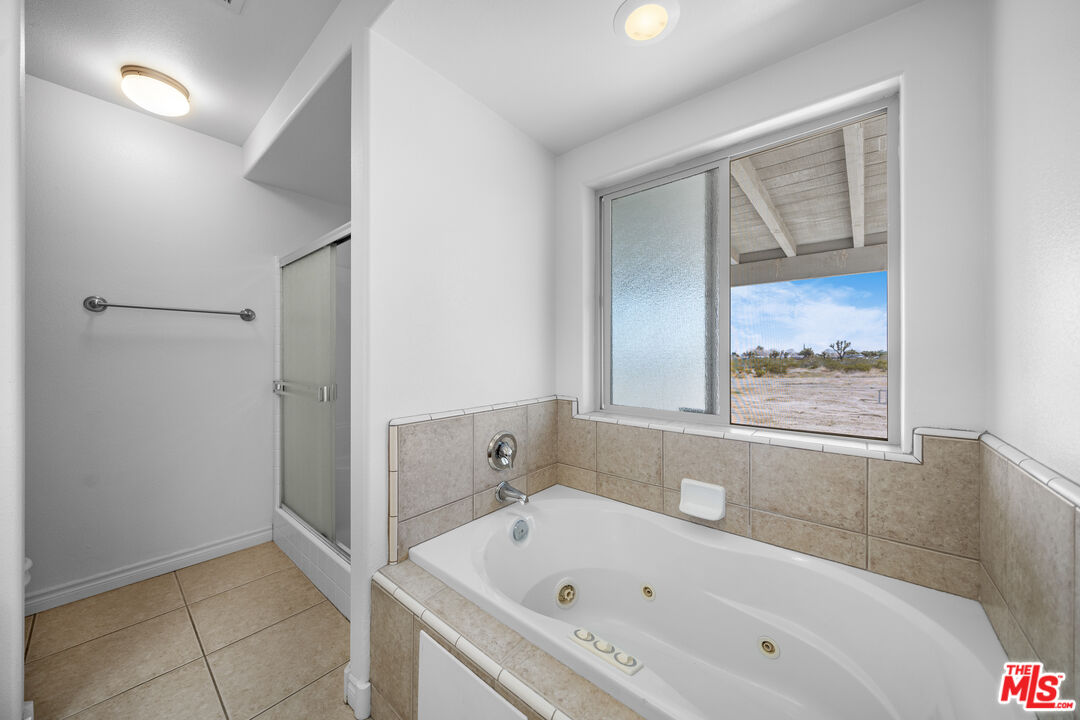 11635 Lebec Road Phelan, CA 92371 - Photo 17 of 35 a bathroom with a bathtub and a shower