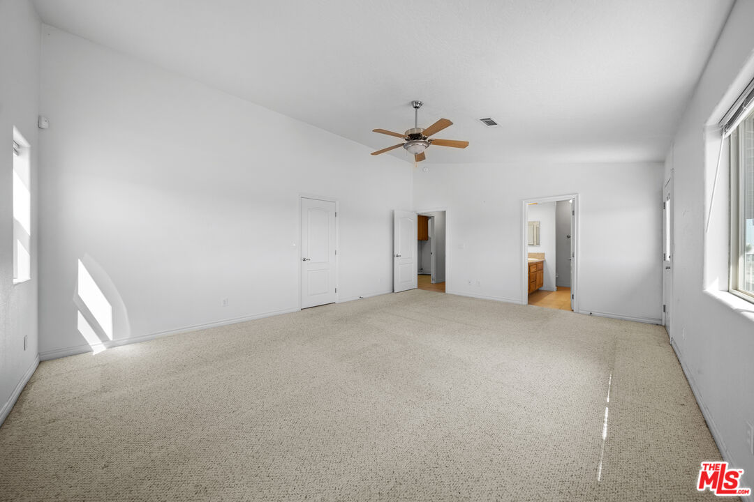 11635 Lebec Road Phelan, CA 92371 - Photo 21 of 35 a view of a livingroom with a ceiling fan and window