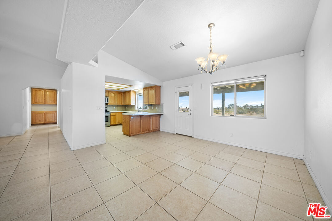 11635 Lebec Road Phelan, CA 92371 - Photo 22 of 35 an empty room with windows and cabinet