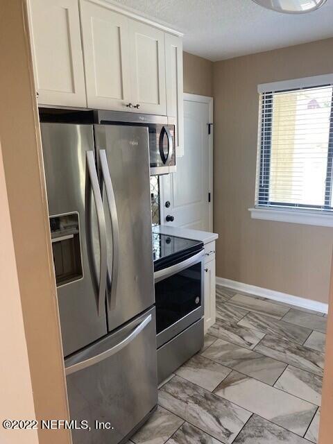 1789 River Road, Unit 2 Jacksonville, FL 32207 - Photo 16 of 22 a metallic refrigerator freezer sitting inside of a kitchen