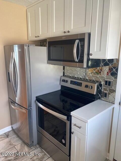 1789 River Road, Unit 2 Jacksonville, FL 32207 - Photo 17 of 22 a kitchen with stainless steel appliances granite countertop a stove a refrigerator and a microwave