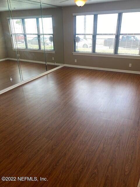 1789 River Road, Unit 2 Jacksonville, FL 32207 - Photo 3 of 22 an empty room with wooden floor and windows