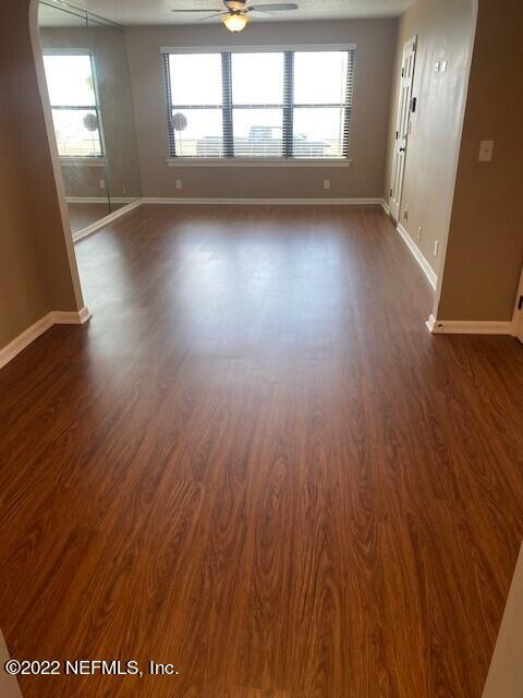 1789 River Road, Unit 2 Jacksonville, FL 32207 - Photo 4 of 22 wooden floor in an empty room with a window