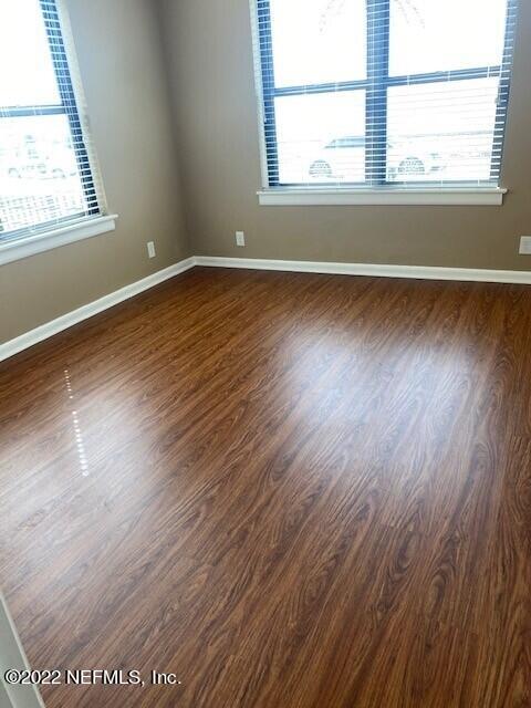 1789 River Road, Unit 2 Jacksonville, FL 32207 - Photo 7 of 22 an empty room with wooden floor and windows