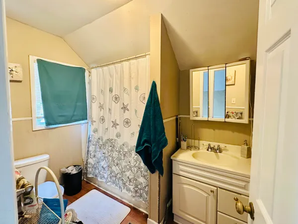 a bathroom with a sink a toilet and a tub
