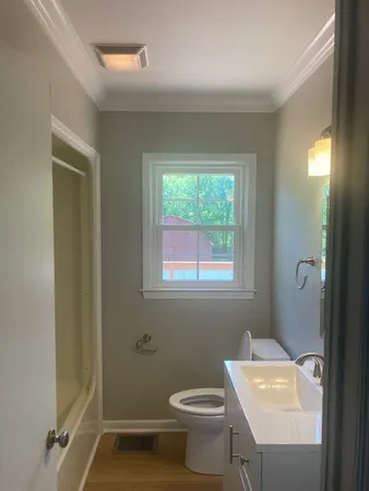 a bathroom with a sink a toilet and a mirror