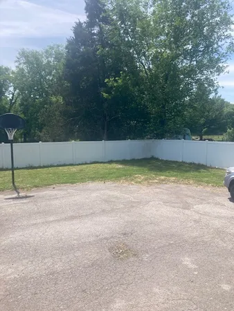 a view of a swimming pool and a yard