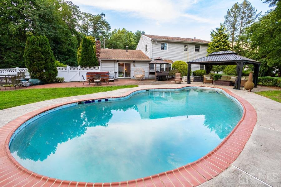 17 Ridgewood Avenue Monroe Township, NJ 08831 - Photo 15 of 16 a view of a house with swimming pool and sitting area