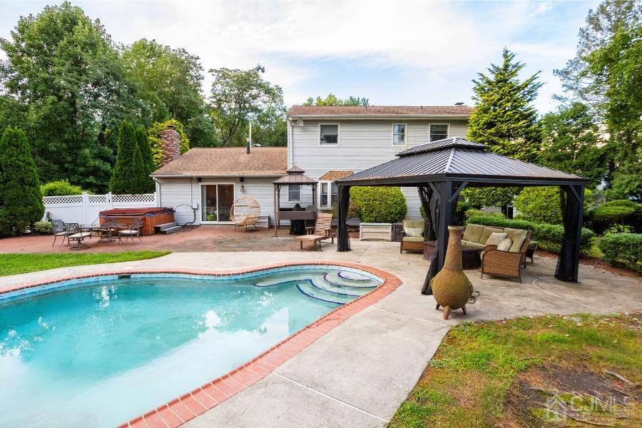 17 Ridgewood Avenue Monroe Township, NJ 08831 - Photo 16 of 16 a view of a house with swimming pool and sitting area