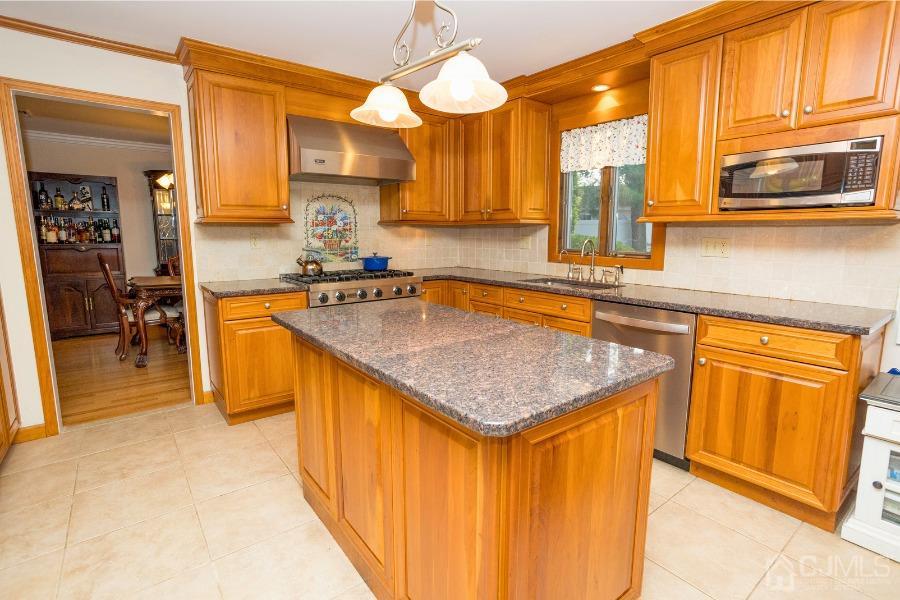 17 Ridgewood Avenue Monroe Township, NJ 08831 - Photo 3 of 16 a kitchen with stainless steel appliances granite countertop a sink and cabinets