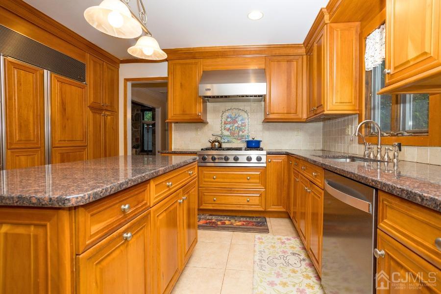 17 Ridgewood Avenue Monroe Township, NJ 08831 - Photo 4 of 16 a kitchen with stainless steel appliances granite countertop a sink and cabinets