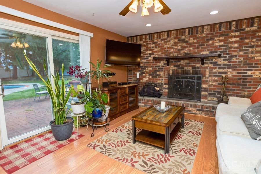 17 Ridgewood Avenue Monroe Township, NJ 08831 - Photo 6 of 16 a living room with patio furniture and a potted plant