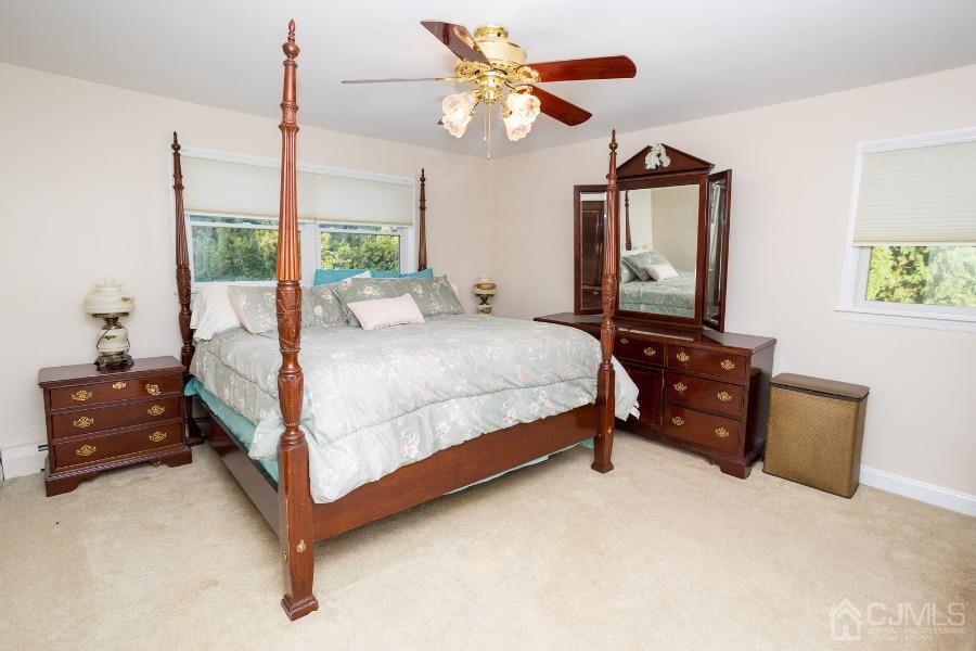 17 Ridgewood Avenue Monroe Township, NJ 08831 - Photo 8 of 16 a bedroom with a bed chandelier and a window