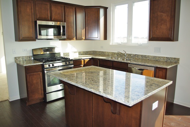 681 Ridgeview Lane Sugar Grove, IL 60554 - Photo 7 of 19 a kitchen with stainless steel appliances granite countertop a sink a microwave counter space and wooden floor