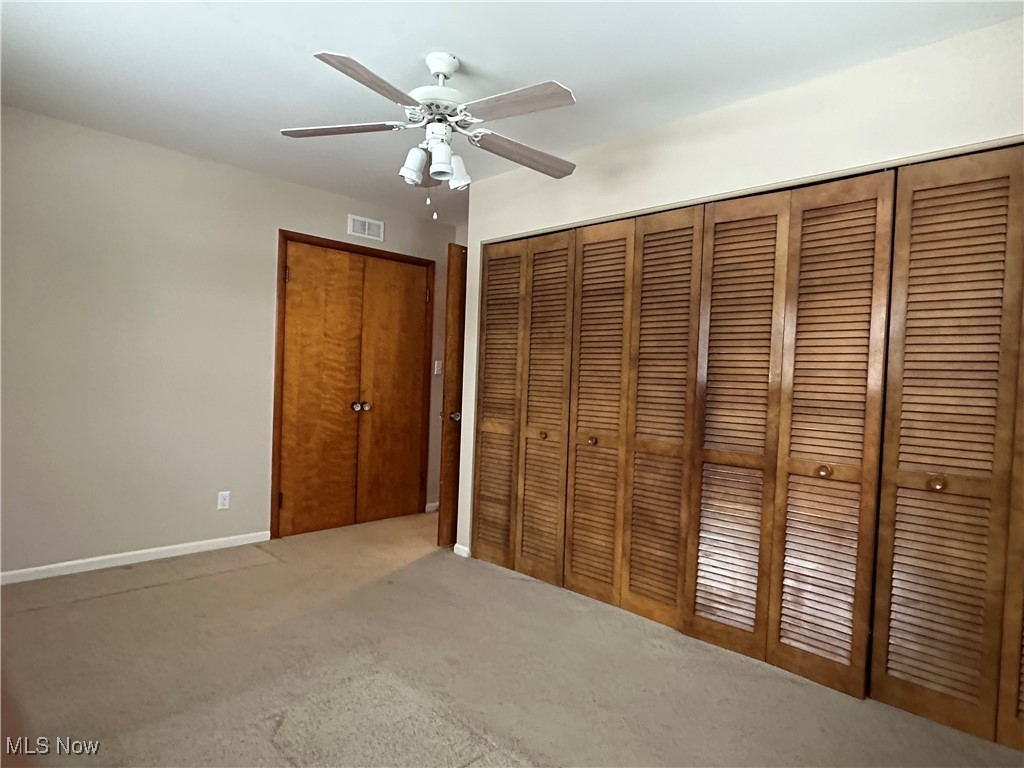 4811 West Pleasant Valley Road Cleveland, OH 44129 - Photo 14 of 31 Unfurnished bedroom featuring carpet floors, a ceiling fan, and a closet