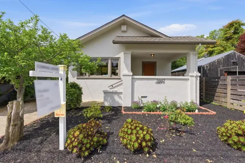 a view of a house with a yard and plants