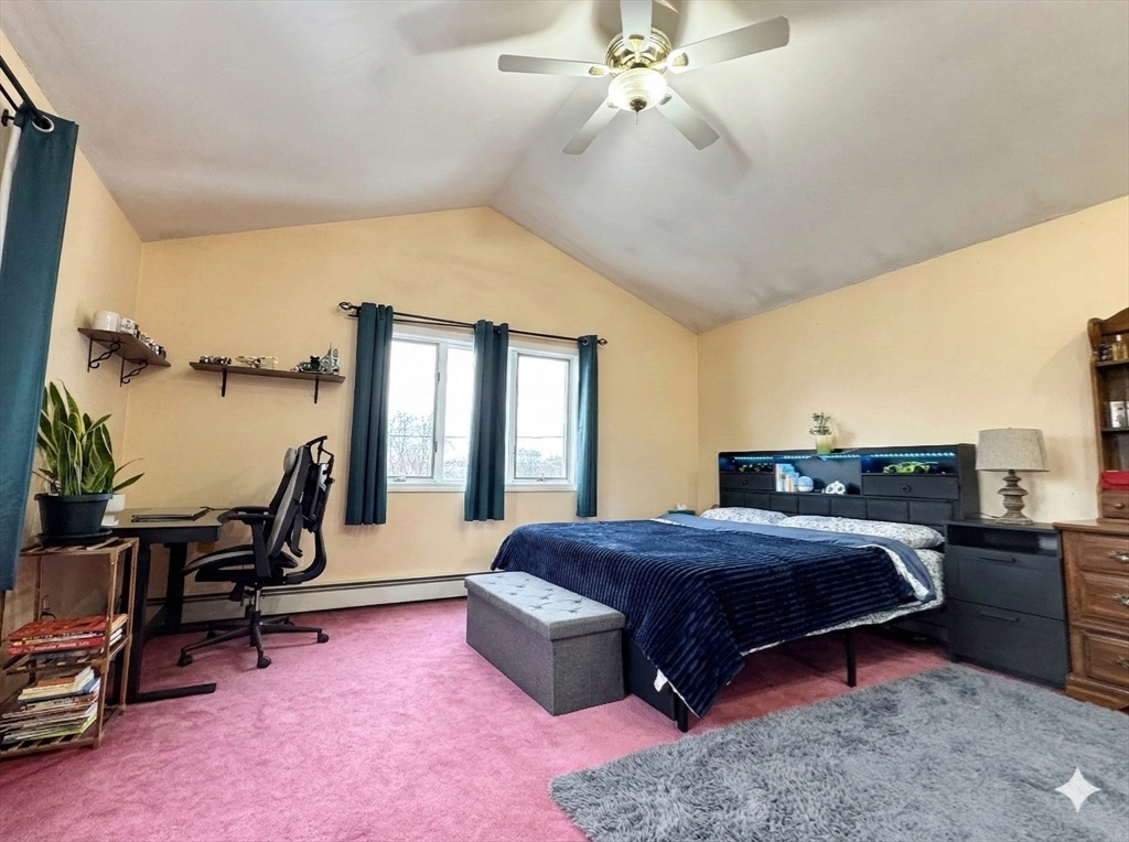 47 Shawmut Street Revere, MA 02151 - Photo 11 of 36 a bedroom with a bed a desk and chair