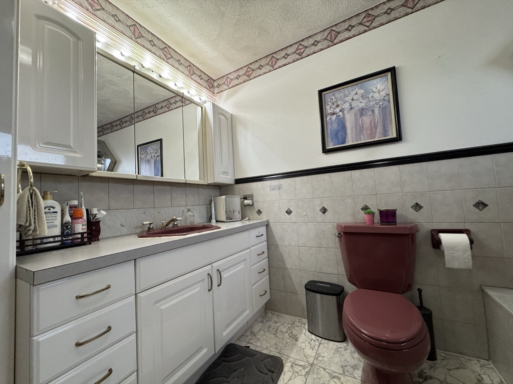 47 Shawmut Street Revere, MA 02151 - Photo 12 of 36 a bathroom with a toilet a sink and mirror