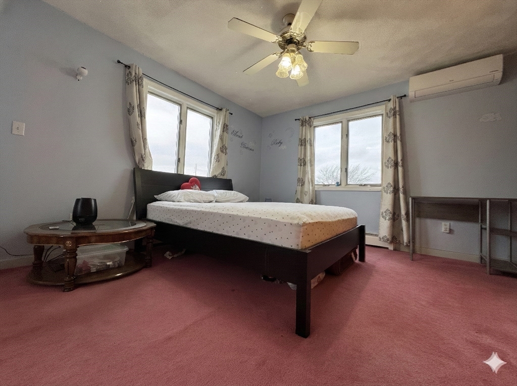 47 Shawmut Street Revere, MA 02151 - Photo 15 of 36 a bedroom with a bed dresser and a window