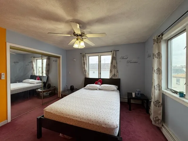 a bedroom with a large bed and a window