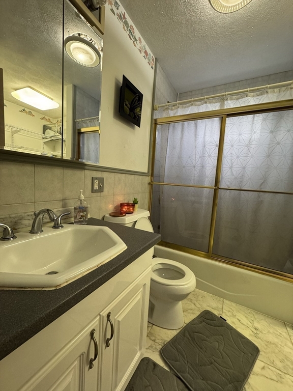 47 Shawmut Street Revere, MA 02151 - Photo 20 of 36 a bathroom with a sink a mirror a toilet and bathtub