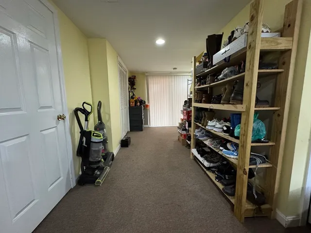 a view of a livingroom with wooden floor and a bathroom