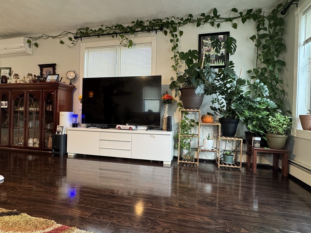 47 Shawmut Street Revere, MA 02151 - Photo 3 of 36 a living room with furniture and a fireplace