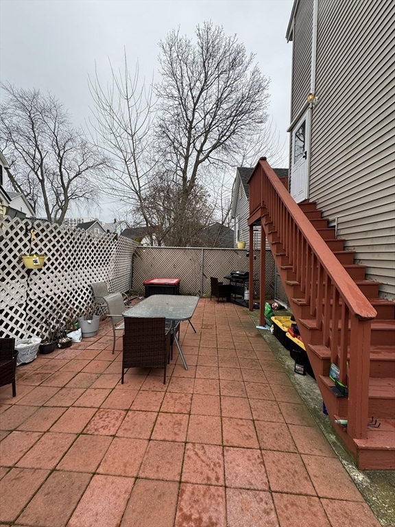 47 Shawmut Street Revere, MA 02151 - Photo 35 of 36 a backyard of a house with barbeque oven and wooden fence