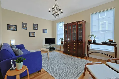 a kitchen with stainless steel appliances granite countertop a refrigerator a stove and a sink with wooden floors
