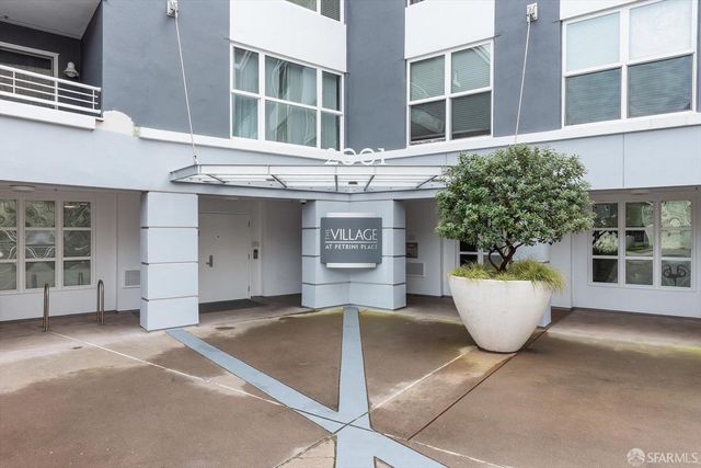 a view of a white building with large windows