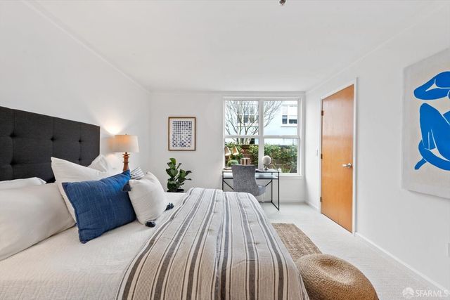 a bedroom with a bed and a table in it