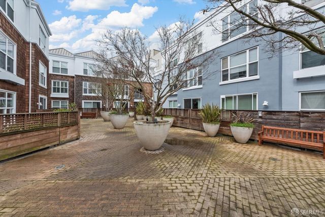 a view of a patio with table and chairs