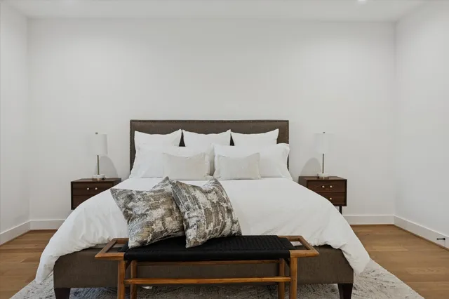 a bedroom with a large bed and a chandelier