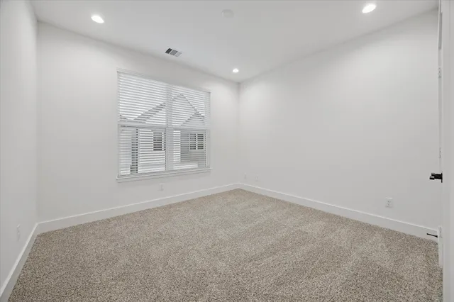 an empty room with a empty space and windows