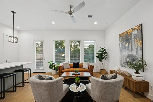 a living room with furniture and a potted plant