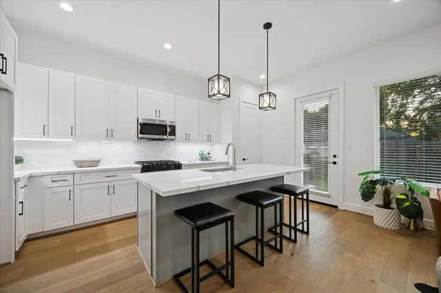a kitchen with sink cabinets and wooden floor