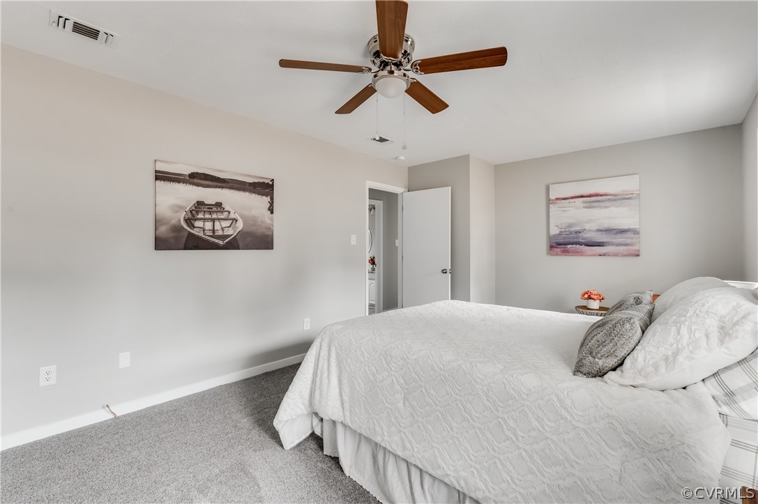 15615 Roland View Drive Chester, VA 23831 - Photo 20 of 35 a bedroom with a large bed and a ceiling fan