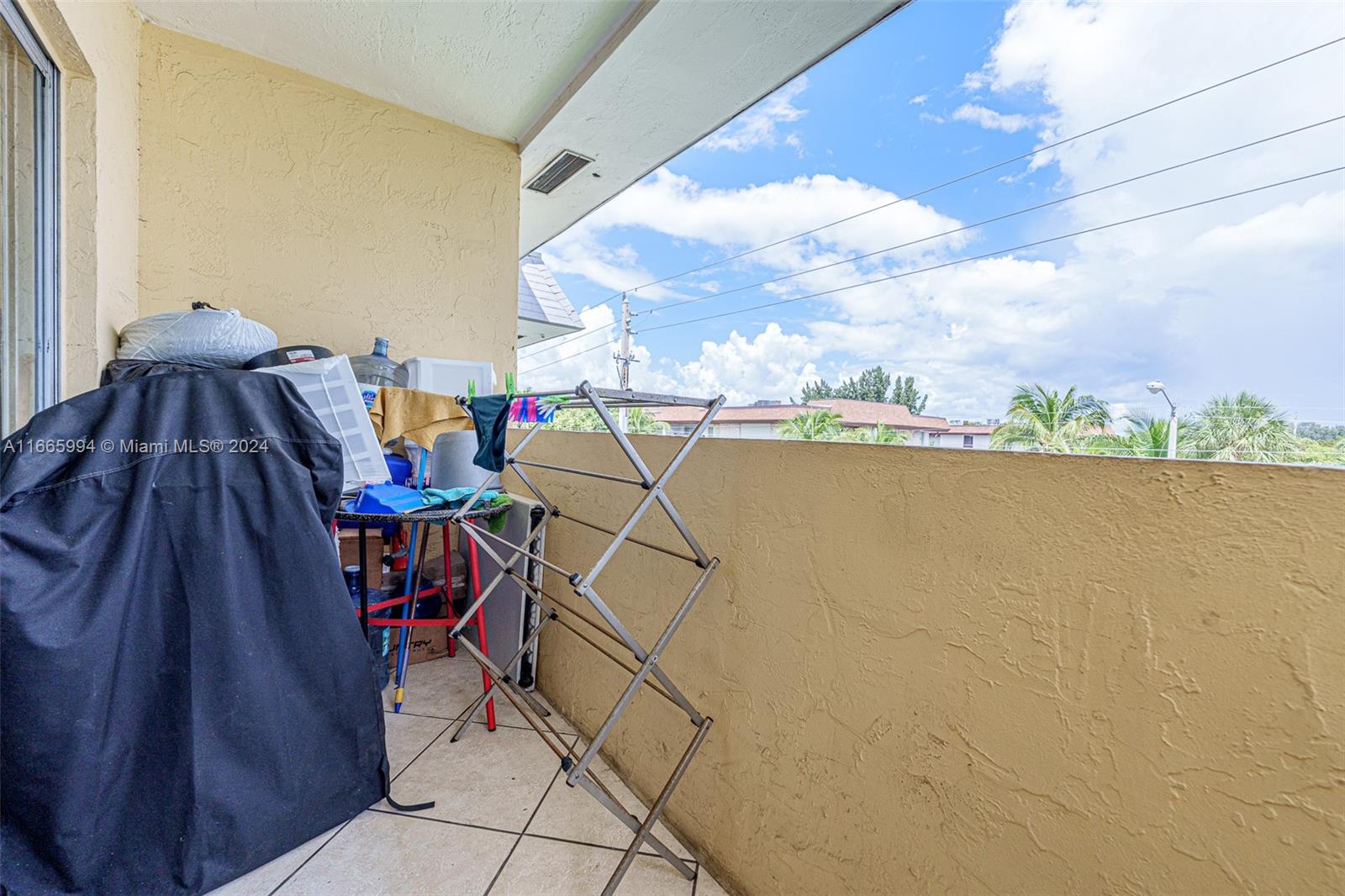7410 Southwest 82nd Street, Unit K302 Miami, FL 33143 - Photo 14 of 34 a view of a terrace with furniture and a floor to ceiling window