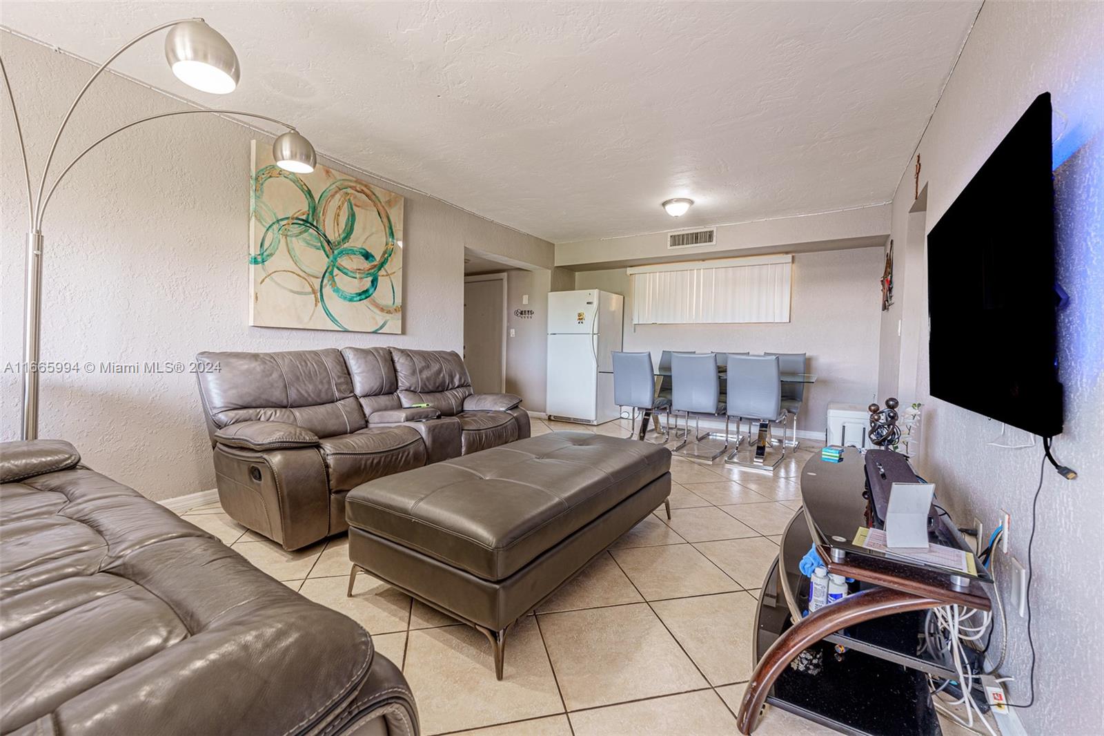 7410 Southwest 82nd Street, Unit K302 Miami, FL 33143 - Photo 21 of 34 a living room with furniture and a flat screen tv