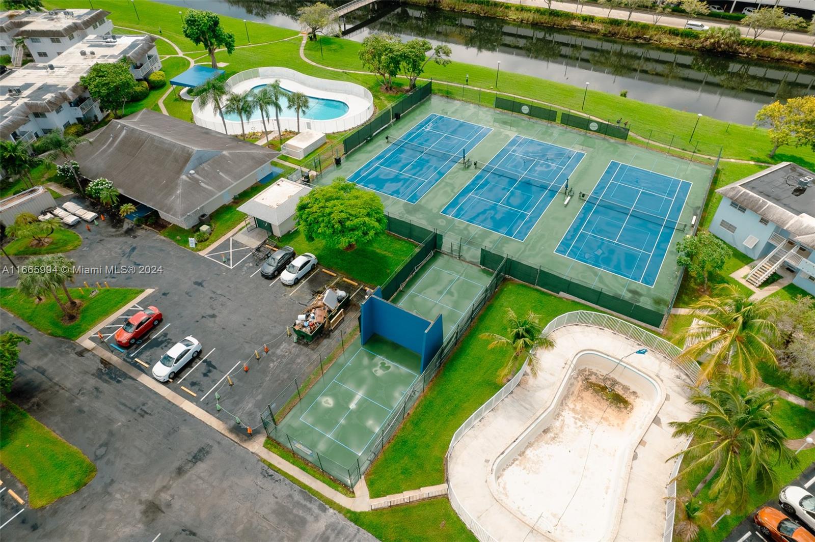 7410 Southwest 82nd Street, Unit K302 Miami, FL 33143 - Photo 32 of 34 an aerial view of a house with a yard and lake view