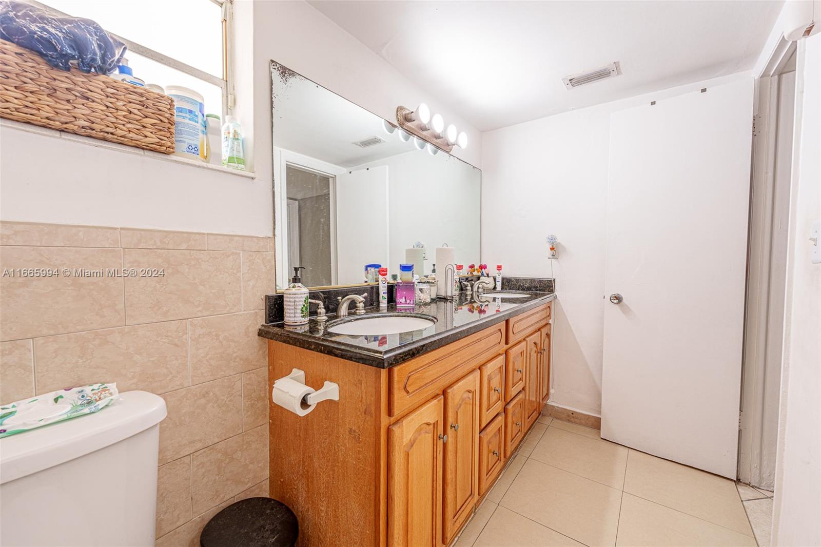 7410 Southwest 82nd Street, Unit K302 Miami, FL 33143 - Photo 6 of 34 a bathroom with a sink a vanity and a mirror