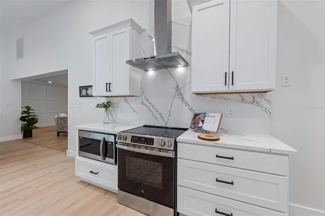 a kitchen with white cabinets and white appliances