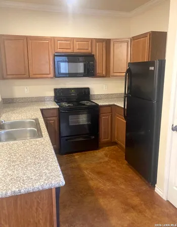 a kitchen with stainless steel appliances granite countertop a refrigerator stove and microwave