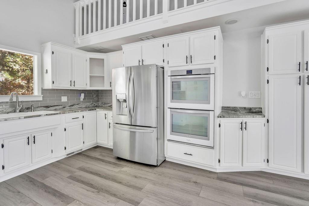 357 John's Way Talking Rock, GA 30175 - Photo 16 of 63 a kitchen with granite countertop white cabinets and stainless steel appliances