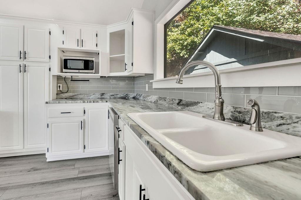 357 John's Way Talking Rock, GA 30175 - Photo 18 of 63 a kitchen with stainless steel appliances a sink a stove a microwave and cabinets