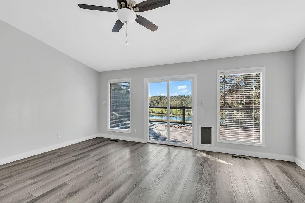 357 John's Way Talking Rock, GA 30175 - Photo 22 of 63 a view of an empty room with a window and wooden floor