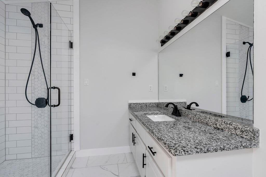 357 John's Way Talking Rock, GA 30175 - Photo 26 of 63 a bathroom with a granite countertop sink a shower and a mirror