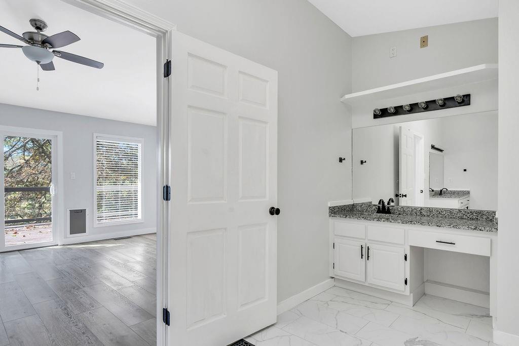 357 John's Way Talking Rock, GA 30175 - Photo 28 of 63 a bathroom with a granite countertop sink a mirror and shower