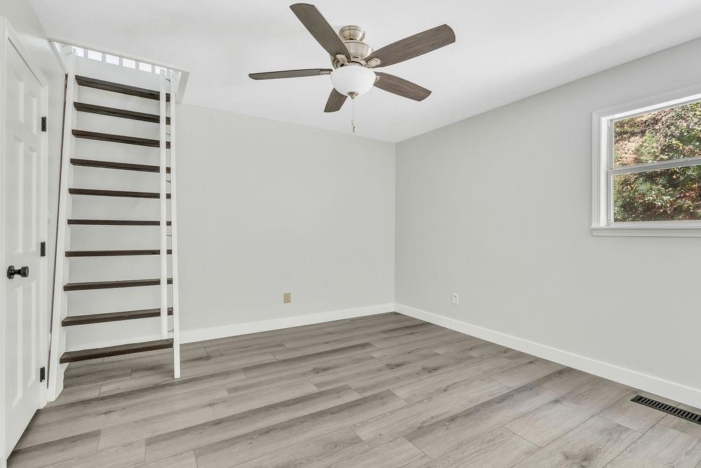 357 John's Way Talking Rock, GA 30175 - Photo 29 of 63 an empty room with wooden floor and windows