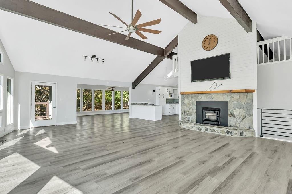 357 John's Way Talking Rock, GA 30175 - Photo 10 of 63 a view of an empty room with wooden floor and a fireplace